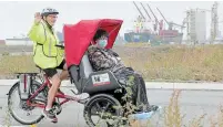  ?? CATHIE COWARD THE HAMILTON SPECTATOR ?? Lorraine Chapman pilots a trishaw — a three-wheel electric bike — as Lynne John enjoys the ride near Pier 8 in Hamilton.