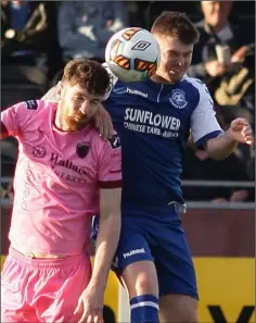  ??  ?? Seán Hurley in a 50-50 battle for possession with a Crumlin United opponent during Friday’s FAI Cup clash.