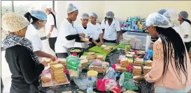  ?? Picture: SISIPHO ZAMXAKA ?? DOING THEIR BIT: Amaqhaweka­zi, a group of young girls prepare 1 000 ‘love sandwiches’ for the less fortunate youth in East London’s Nompumelel­o informal settlement