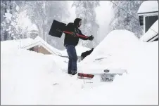  ?? AP PHOTO/JAE C. HONG ?? Kenny Rybak, 31, shovels snow around his car in Running Springs, Calif., on Tuesday.