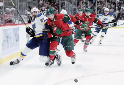  ??  ?? ST PAUL: Patrik Berglund #21 of the St Louis Blues and Marco Scandella #6 of the Minnesota Wild skate after the puck during the second period of the game on Tuesday at Xcel Energy Center in St Paul, Minnesota. The Blues defeated the Wild 2-1. —AFP