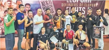  ??  ?? Boy Prata (front, second left) and Addyqa (standing, third right) with fellow Sarawakian fighters, other contestant­s and event officials in a group photo.