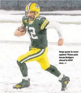  ?? AP ?? Huge game in snow against Titans puts Aaron Rodgers ahead in MVP race.