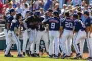  ?? JOHN PETERSON / AP ?? Mississipp­i’s Jacob Gonzalez celebrates his home run against Oklahoma with teammates in the NCAA College World Series baseball finals, Sunday.