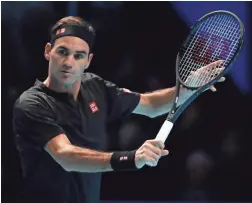  ??  ?? Roger Federer plays a return to Matteo Berrettini during their ATP Finals match on Tuesday at the O2 Arena in London.