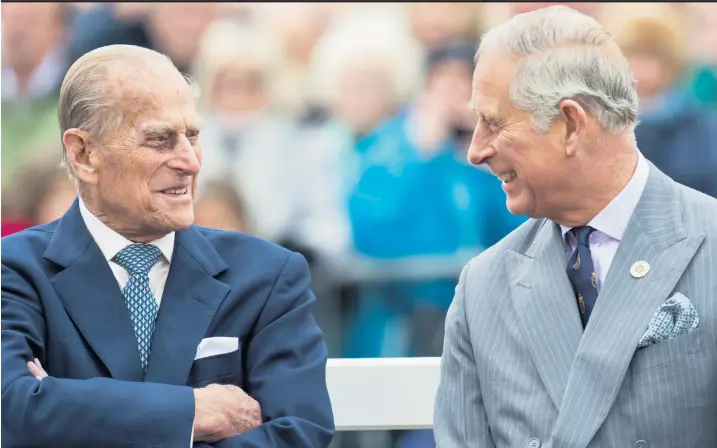  ??  ?? The Duke of Edinburgh and Prince of Wales grew increasing­ly close in recent years. Below, crowds pay tribute at Windsor Castle yesterday