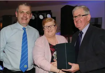  ??  ?? Above: Margaret O’Callaghan who was honoured for her outstandin­g dedication to the club is pictured with Donal Sheahan (Chairman), and Joe Kearns (Duhallow Board Chairman), at the Kilbrin GAA Medals Presentati­on Event.