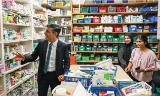  ?? ?? Strong medicine: Rishi Sunak visiting his mother’s former pharmacy