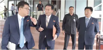  ??  ?? Representa­tives from North Korea leave after a meeting with members of the South Korea and Olympic Council of Asia at its headquarte­r in Jakarta. — AFP photo