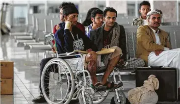  ?? Mohammed Huwais / AFP / Getty Images ?? Men injured in a bombing that killed 140 wait in the airport Saturday in Sanaa, the rebel-held Yemeni capital, for evacuation to Oman for treatment. About 115 of the most seriously wounded were to be evacuated.