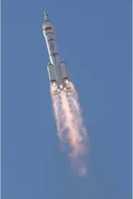  ?? (Carlos Garcia Rawlins/Reuters) ?? THE LONG MARCH-2F Y12 rocket with three astronauts aboard takes off yesterday from Jiuquan Satellite Launch Center for China’s first manned mission to build its space station.