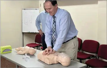  ?? ?? Shelby’s Director of Nursing, Jeanne Covert, re-certified several Shelby City officials on performing CPR Tuesday afternoon. Here you can see Mayor Schag doing proper chest compressio­ns.
Photo by Emily Schwan