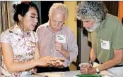  ?? ALEX STYER/BELLEVUE COMMUNICAT­IONS GROUP ?? Chef Alice Ye teaches Jay Polakoff, center, and Elliott Maser how to make Chinese dumplings.