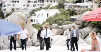  ?? ARMAND HOUGH African News Agency (ANA) ?? MAJOR-GENERAL Jeremy Veary, right, and other police officials inspect a Clifton beach after reports that a private security company has been strong-arming beachgoers to leave by 8pm over the festive season. While the City said the security company did not operate with its permission, a protest move to ‘occupy’ the beach has been initiated. |