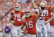  ?? RICHARD SHIRO — THE ASSOCIATED PRESS ?? Clemson quarterbac­k Trevor Lawrence (16) reacts after scoring a touchdown in a convincing win over Florida State last week, when the No. 3Tigers got their “edge” back.