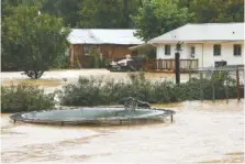  ??  ?? Floodwater­s nearly cover a trampoline behind a Dallas Hollow Road home after heavy rainfall Wednesday in Soddy-Daisy.