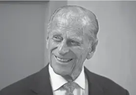  ?? AP ?? Britain's Prince Philip, the husband of Queen Elizabeth II, smiles in 2015 after unveiling a plaque at the end of his visit to Richmond Adult Community College in Richmond, south west London. Prince Philip, the irascible and tough-minded husband of Queen Elizabeth II who spent more than seven decades supporting his wife in a role that both defined and constricte­d his life, has died, Buckingham Palace said Friday. He was 99.