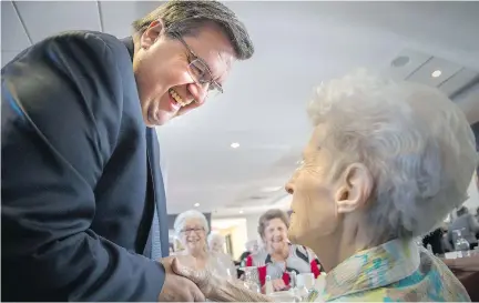  ?? PETER McCABE ?? Denis Coderre visits the Sommet de la Rive seniors residence in Verdun last week. Interactin­g with people gives him energy, he says, though he sleeps four hours a night and regrets the time away from his family. He says the city is enjoying a renewed...