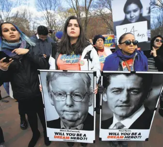  ?? Manuel Balce Ceneta / Associated Press ?? Amanda Bayer (center) and Marisol Maqueda hold placards outside the White House this month, seeking support for “Dreamers” like Maqueda’s daughter, a master’s student in Arizona, who were brought illegally to the U.S. as small children and know no...