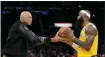  ?? ASHLEY LANDIS — THE ASSOCIATED PRESS ?? Kareem Abdul-jabbar, left, hands the ball to Los Angeles Lakers forward Lebron James after passing Abdul-jabbar to become the NBA’S all-time leading scorer.