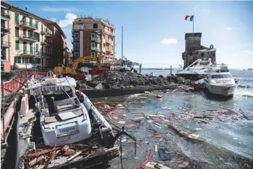  ??  ?? ABOVE Rapallo harbour was particular­ly badly hit BELOW Dozens of boats were washed up on the shore