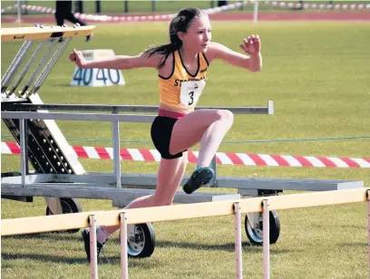  ??  ?? ●●Rebecca Cox on her way to a double in the hurdles and high jump