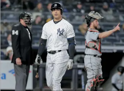  ?? JULIE JACOBSON — THE ASSOCIATED PRESS ?? Yabnkees’ Giancarlo Stanton walks back to dugout after striking out against Marlins during Monday’s game at Yankee Stadium.