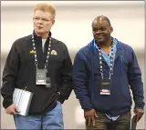  ?? Canadian Press photo ?? Hamilton Tiger-Cats general manager Eric Tillman, left, and Winnipeg Blue Bombers defensive coordinato­r Richie Hall, right, chat while assessing talent during the 2017 CFL Combine at the Co-operators Centre in Regina Saturday.