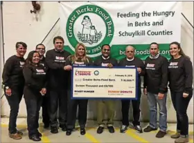  ?? SUBMITTED PHOTO ?? Dunkin’ Donuts franchisee­s donated $21,000 to the Greater Berks Food Bank. A check was recently presented to the food bank.
