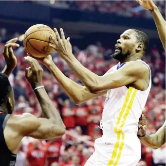  ?? (AP) ?? WARRIORS forward Kevin Durant (35) drives to the basket past Houston Rockets guard James Harden (13) during the first half of Game 1 of the NBA basketball Western Conference Finals, Monday, May 14, 2018, in Houston.