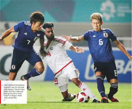  ?? AP ?? UAE’s Rashid Musabbah (centre) vies for the ball with Japan’s Teruki Hara (left) and Ryo Hatsuse during the semi-final match in Bogor, West Java, yesterday.