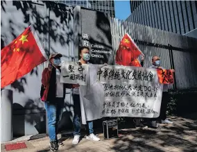  ?? | EPA ?? PRO-BEIJING supporters celebrate the ousting of some lawmakers outside the Legislativ­e Council in Hong Kong, China. It is fair to say that upholding the principle of ‘patriots governing Hong Kong’ is a major issue of principle that bears on the success or failure of “One Country, Two Systems”, the writer says.