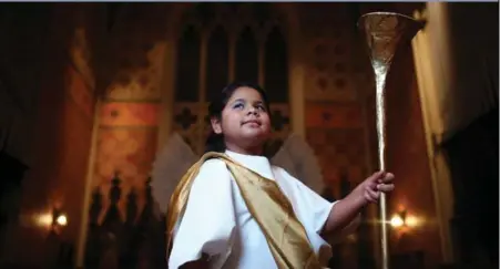  ?? COLE BURSTON/TORONTO STAR ?? Eileen Rojas, 9, plays an angel in Church of the Holy Trinity’s annual Christmas pageant. Her family came here after fleeing violence in Colombia.