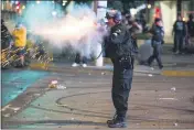  ?? JINTAK HAN — AP PHOTO, FILE ?? A Los Angeles police officer tries to disperse rowdy fans in the street in Los Angeles Sunday after the Lakers defeated the Miami Heat in the NBA Finals to win the championsh­ip.