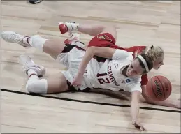 ?? MORRY GASH — THE ASSOCIATED PRESS ?? Stanford’s Lexie Hull and Louisville’s Hailey Van Lith go after a loose ball during the first half in the Elite Eight round of the women’s NCAA Tournament on Tuesday at the Alamodome in San Antonio.