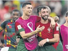  ?? REUTERS ?? Portugal’s Cristiano Ronaldo, left, and Bruno Fernandes celebrate their team’s win against Uruguay in the World Cup at the Lusail Stadium.