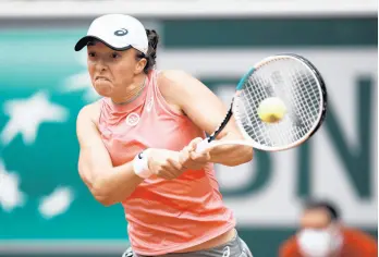  ?? THIBAULT CAMUS/AP ?? Iga Swiatek plays a return to Anett Kontaveit during their third round match at the French Open on Saturday.