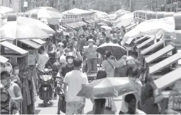  ?? PHILSTAR.COM ?? After breaching target in April, inflation threatens economic recovery. In this undated file photo, market life in virus-hit Philippine­s continues with consumers still flocking to stores.