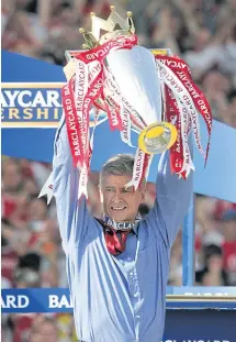  ??  ?? Wenger lifts the Premier League trophy in 2004.