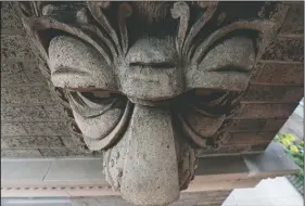  ??  ?? A carved face adorns the side of the former L.S. Ayres department store building next to the Ayres Clock.