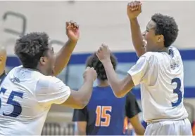  ?? DOUG KAPUSTIN/BALTIMORE SUN MEDIA GROUP ?? Marriotts Ridge’s Austin Aven, left, celebrates with teammate Ira Snell as the Mustangs seal a win over visiting Reservoir on Thursday night in Marriottsv­ille.