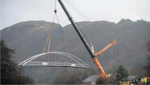  ??  ?? HEAVY METAL: The substantia­l new Glen Nevis Bridge was built in sections in Inverness and then lifted into place by crane