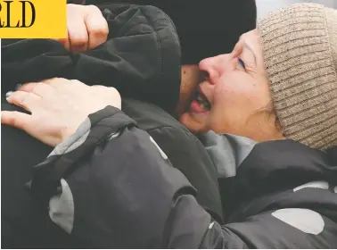  ?? GENYA SAVILOV / AFP VIA GETTY IMAGES ?? Ukrainian Ivan Katyshev is embraced by his mother Lyudmila after being returned during a prisoner exchange
on Sunday between Ukrainian forces and pro-russian separatist­s at a checkpoint near the town of Horlivka.