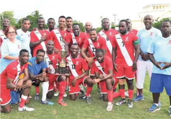  ??  ?? Members of the victorious Scotiabank football team pose with the Norman Goodison Inter-bank trophy after they defeated Jamaica National Building Society at Winchester Park last Sunday.