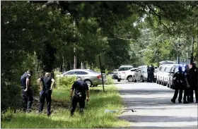  ?? HENRIETTA WILDSMITH — THE SHREVEPORT TIMES VIA AP ?? Shreveport, La., police search the scene of a shooting Wednesday morning. At least three people were killed and 10 others wounded late Tuesday, Shreveport police Sgt. Angie Willhite said.