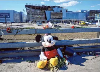  ?? AP ?? Rough reality: Toys and flowers left by mourners lie in front of the Crocus City Hall on the western outskirts of Moscow in Russia on Wednesday.