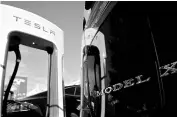  ?? REUTERS ?? A Tesla Model X at a chargin station. Tesla sold $1.8 billion of eight-year unsecured bonds at a yield of 5.30 per cent