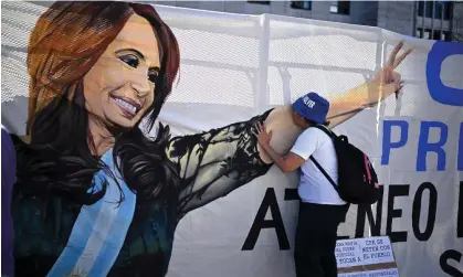  ?? Aires. Photograph: Luis Robayo/AFP/Getty Images ?? A supporter of Argentina's Vice-President Cristina Fernández de Kirchner kisses her image on a banner hung outside a courthouse in Buenos