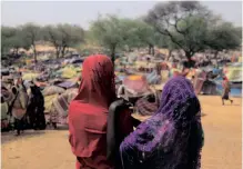  ?? REUTERS ?? SUDANESE girls who fled the conflict in Sudan’s Darfur region look at makeshift shelters near the border between Sudan and Chad, while taking refuge in Borota, Chad. |