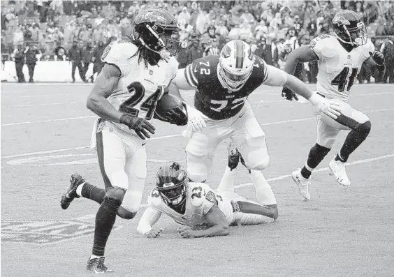  ?? KARL MERTON FERRON/BALTIMORE SUN ?? Ravens cornerback Brandon Carr returns an intercepti­on during the third quarter. Tony Jefferson also had a pick for the Ravens, who held the Bills to just 70 passing yards, the fewest the team has allowed since it gave up 60 to the New York Jets in a 10-9 win Sept. 13, 2010. “Whatever they threw at us, we are able to answer,” outside linebacker Terrell Suggs said.